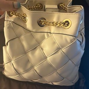 White with gold chain Michael Kors backpack purse brand. We never used